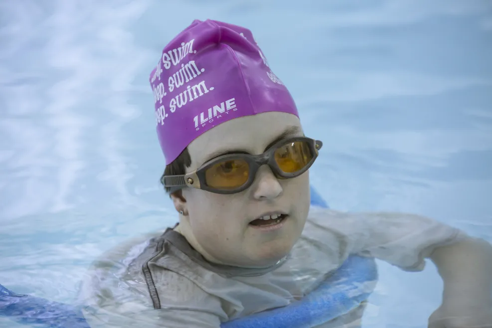 Melissa swimming in a pool.