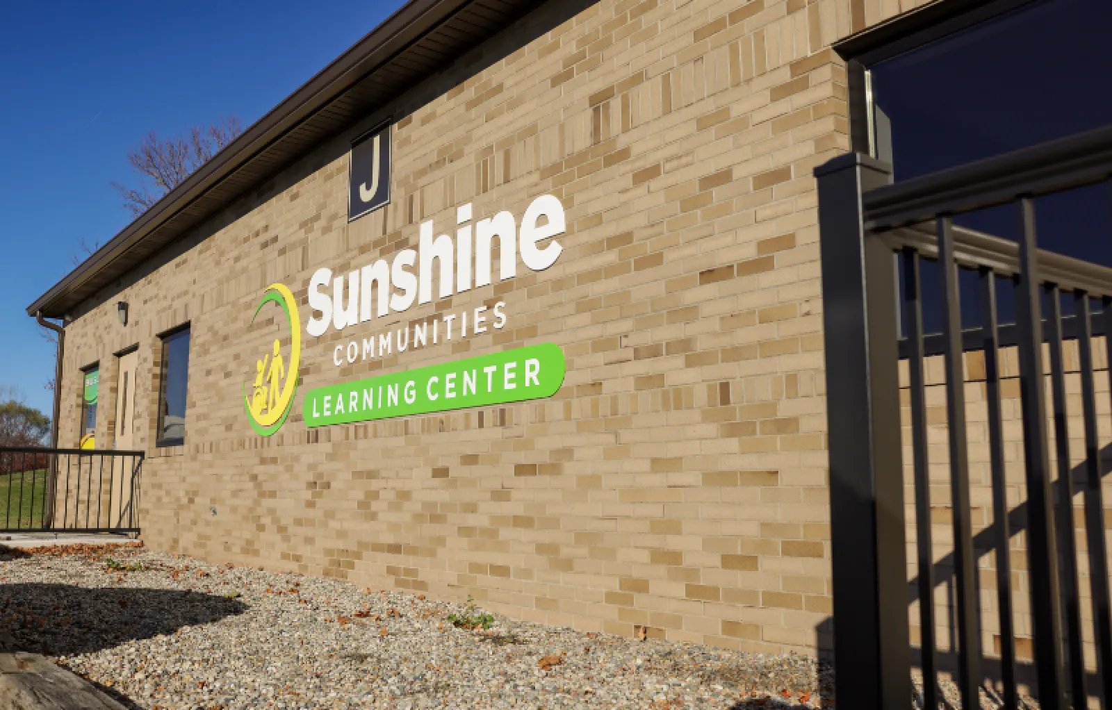 Sunshine Communities Logo on Building