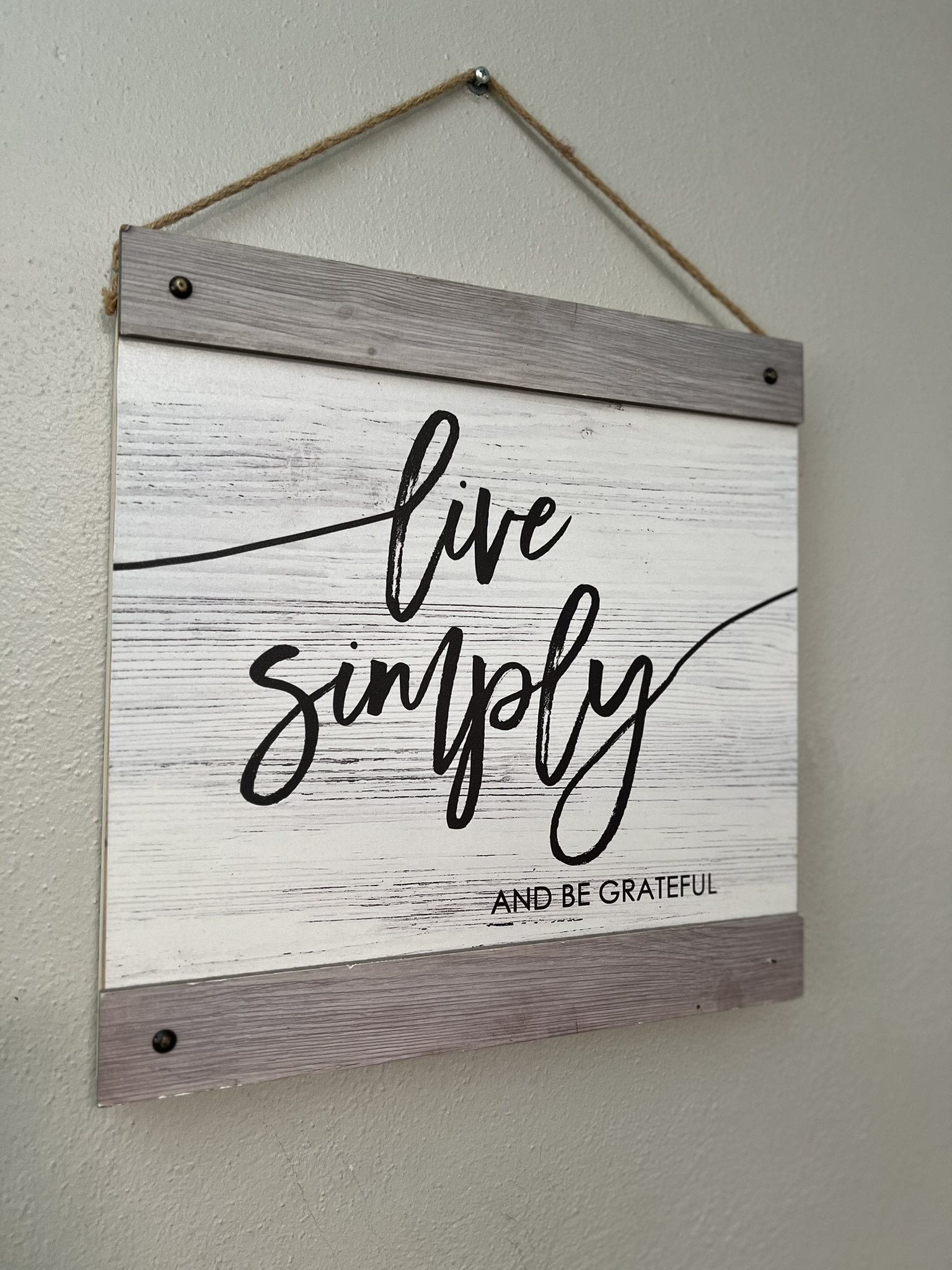 A “Live Simply and Be Grateful” sign hangs on the wall inside a Sunshine Communities home.