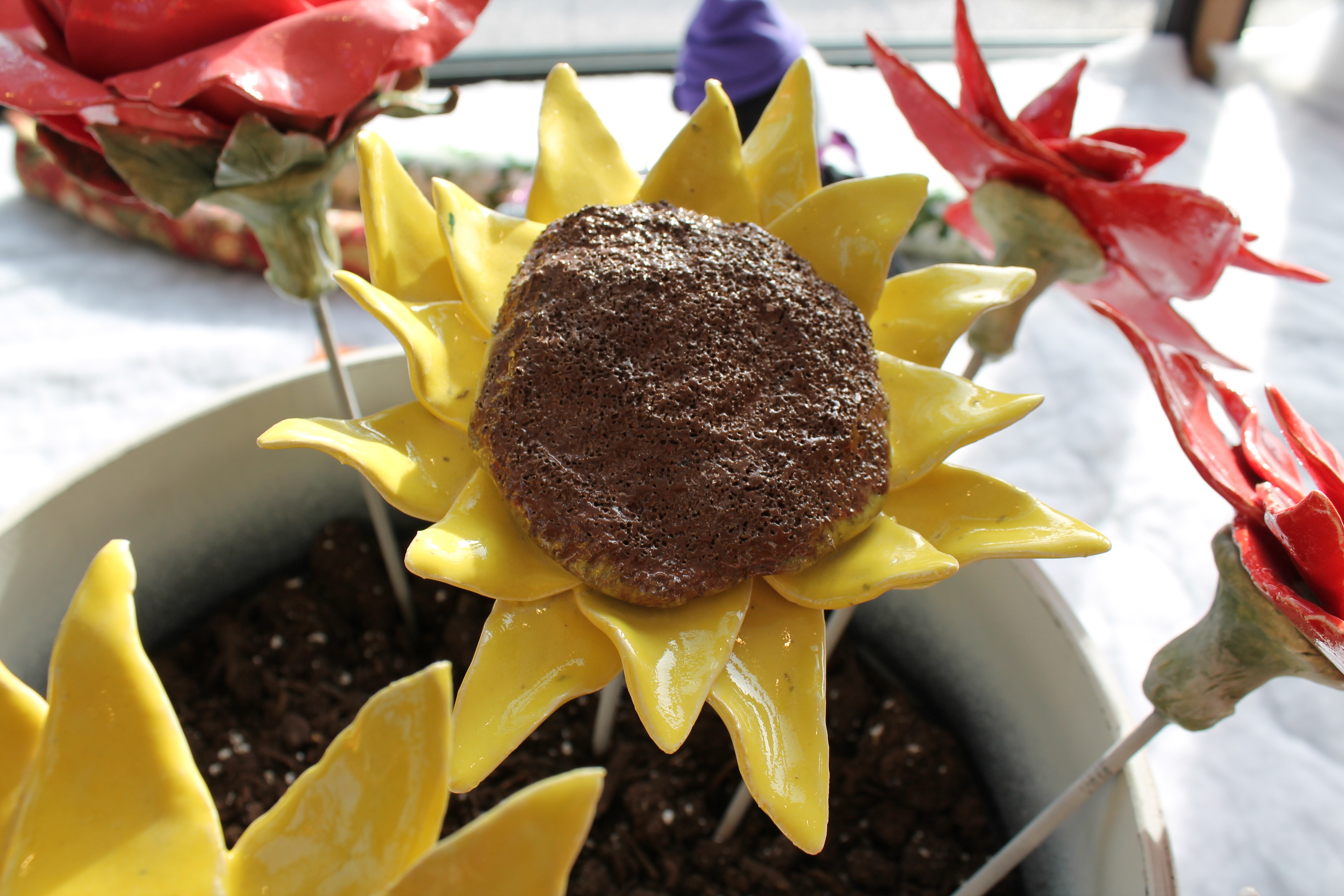 A flower pot with a brown rock nestled inside