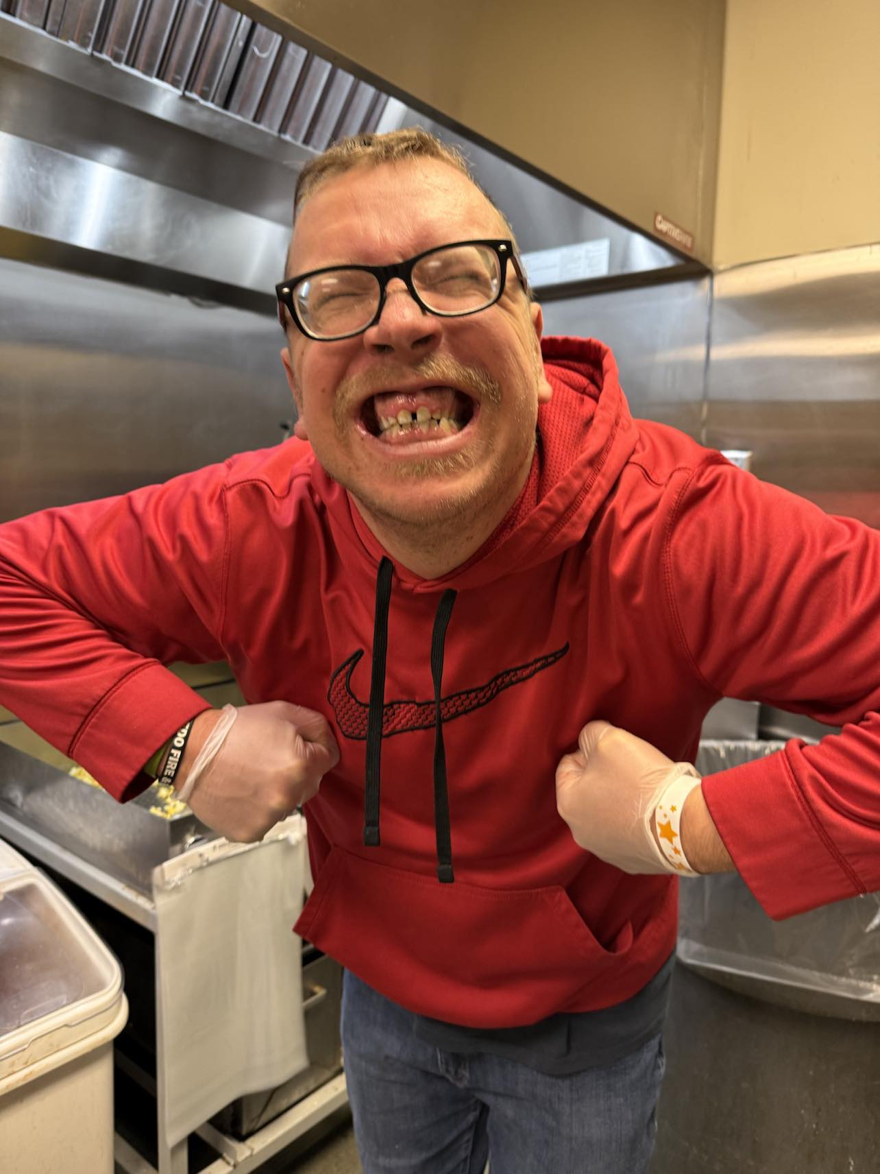 Kelvin Matyi smiling while working in a kitchen