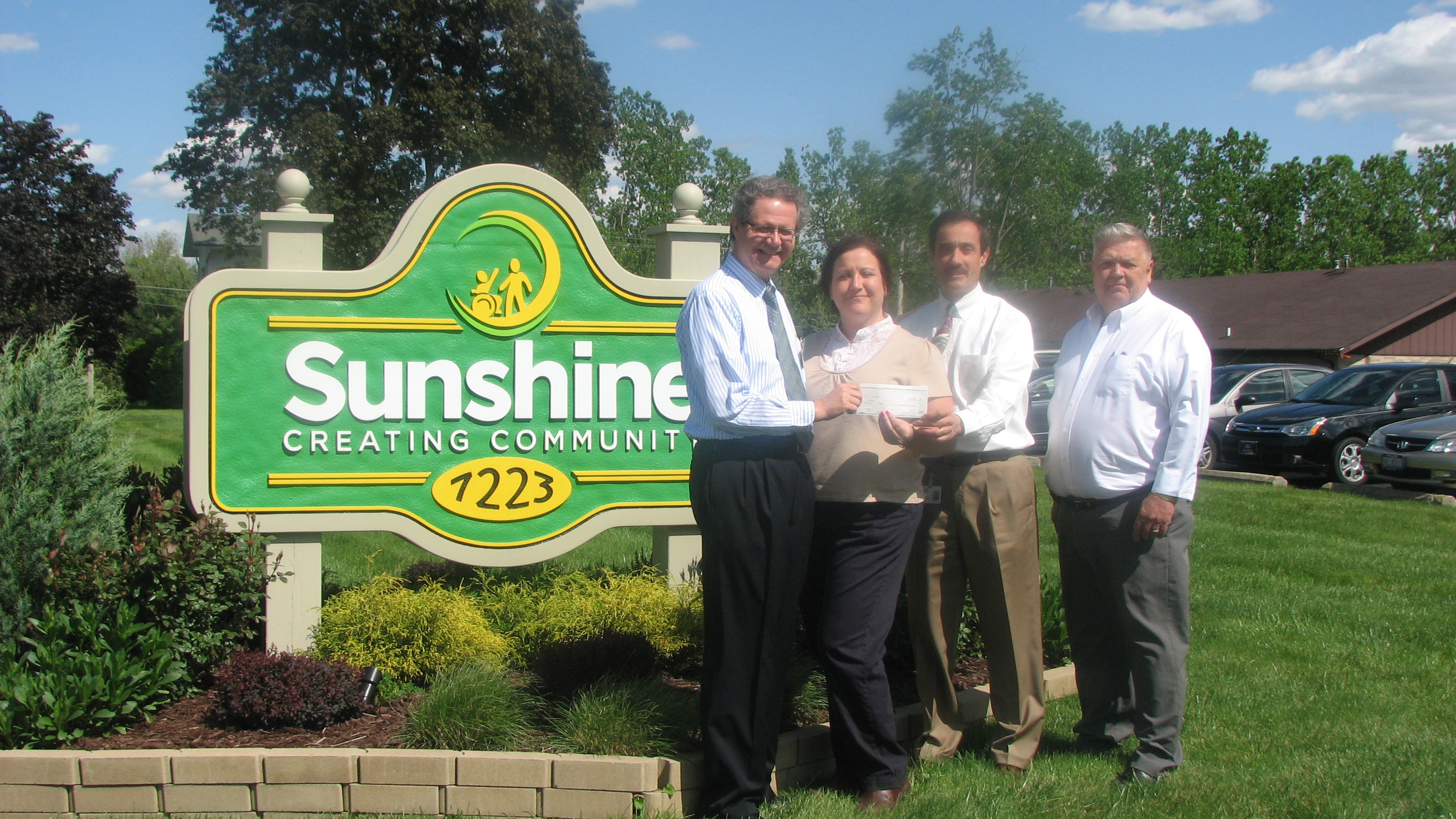Ohio Elks representatives presenting a donation to Sunshine Communities in Maumee.