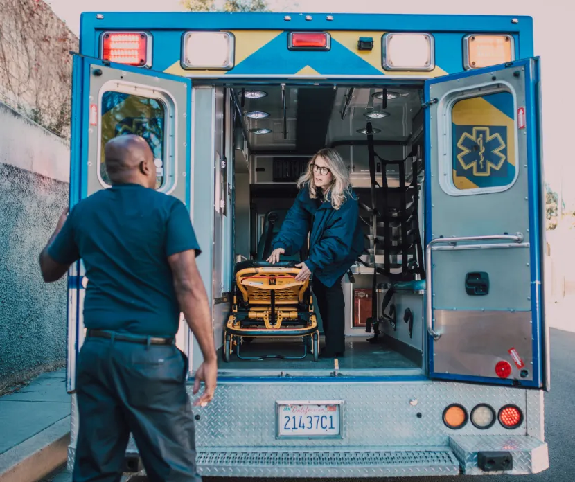 Emergency medical professionals participate in hands-on ambulance training as part of a Sunshine Communities educational program focused on ventilator care, complex medical needs, and emergency response for individuals with developmental disabilities.
