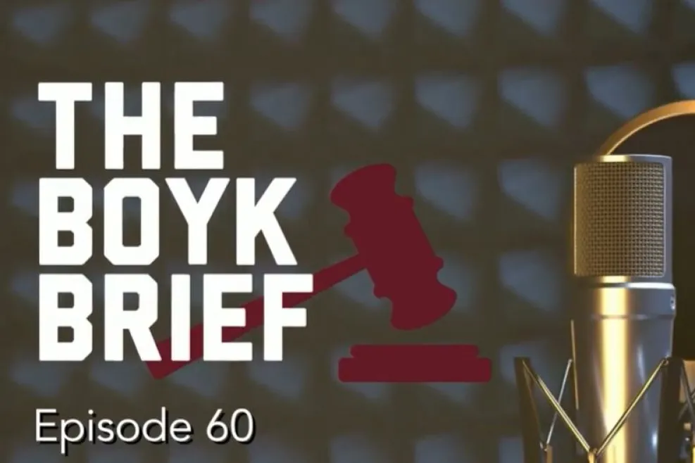 Graphic for The Boyk Brief podcast, Episode 60. Large white text reading "THE BOYK BRIEF" appears on the left over a dark soundproof studio background. A red judge's gavel graphic sits behind the title. On the right is a gold studio microphone with a black pop filter. "Episode 60" appears in white text at the bottom left.
