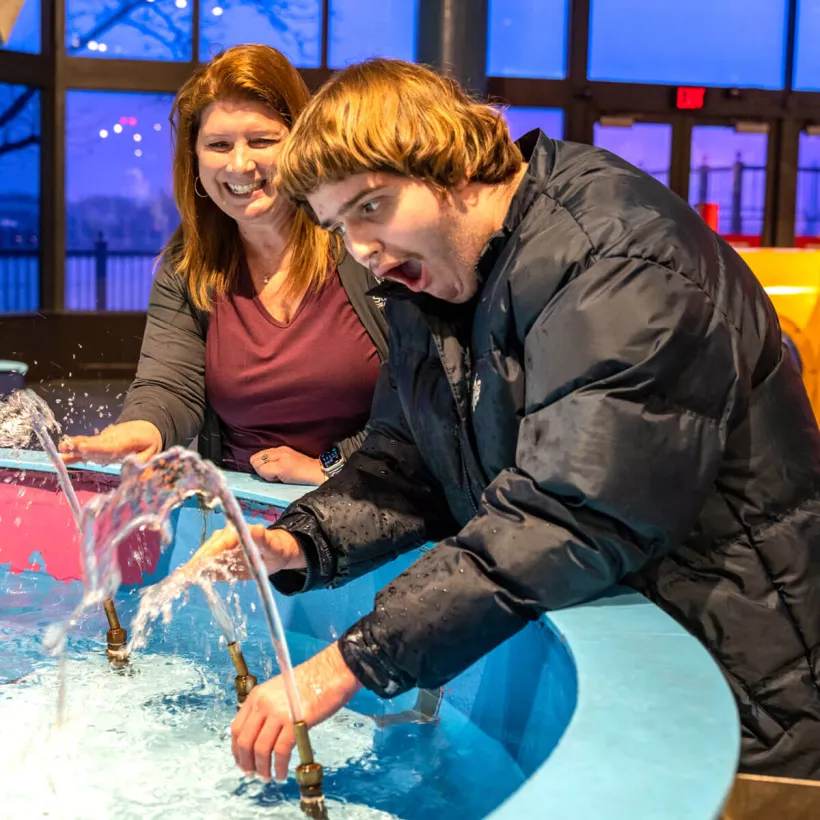 Two People Playing in a Fountain