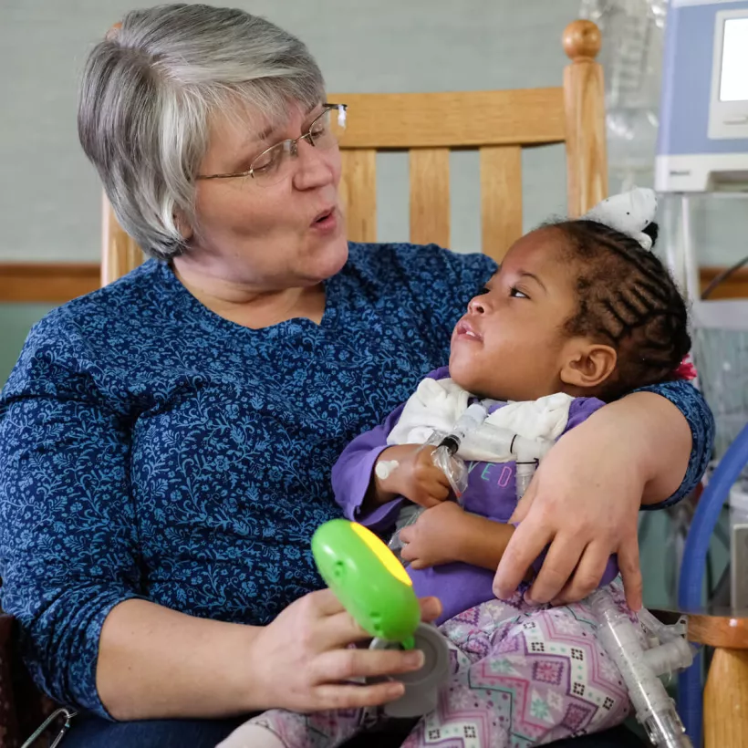 A Woman and Child Sitting in a Chair Together