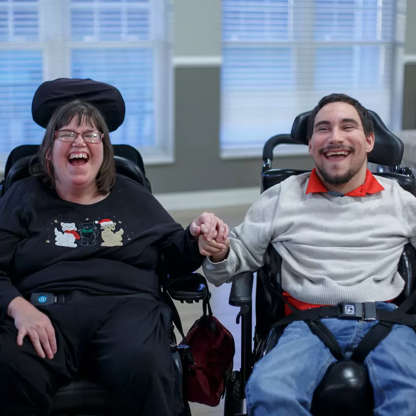 Two People in Wheelchairs Smiling