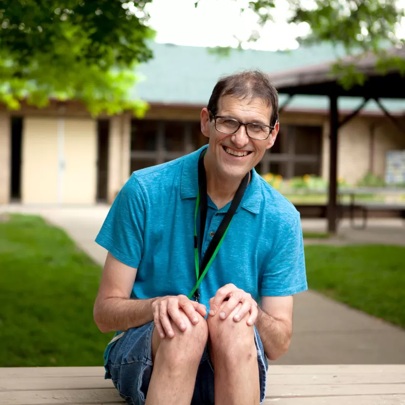 Person Sitting on a Bench Smiling