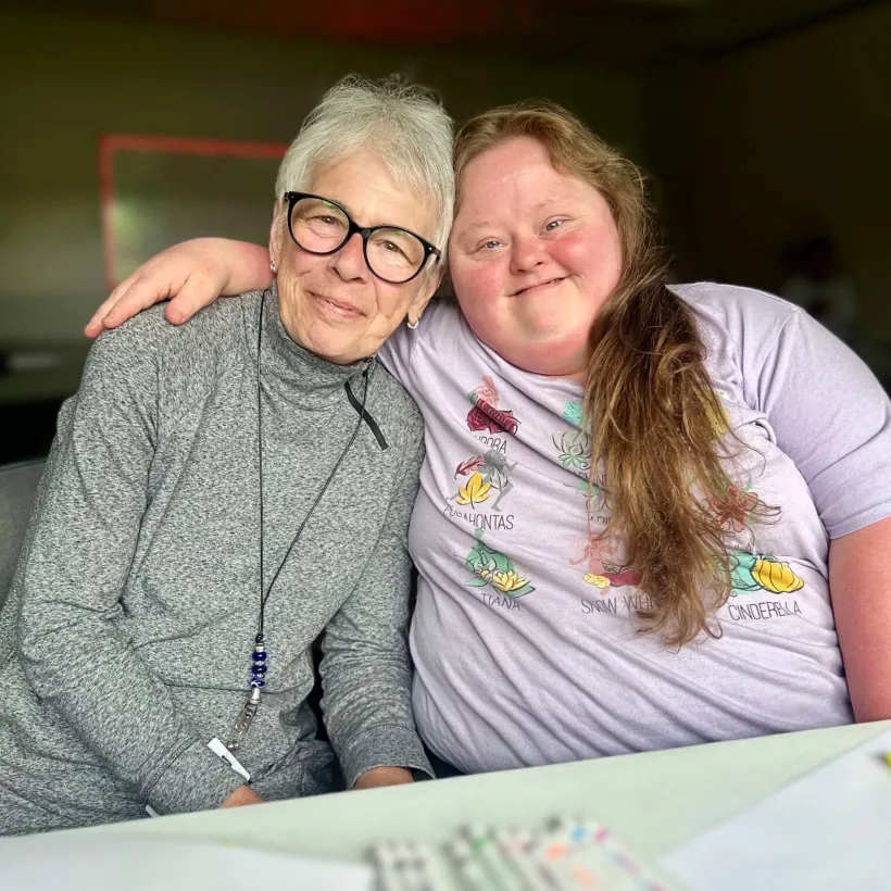 Two individuals hugging