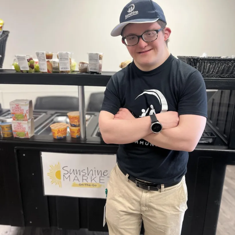 Isaac poses for a photo in front of food