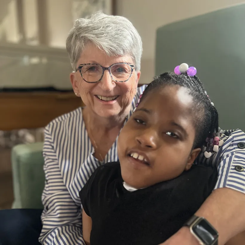 Linda Dittman embraces and kisses Faith on the cheek during a quiet moment together at Sunshine Communities, reflecting the deep compassion and connection that defined her nursing career.