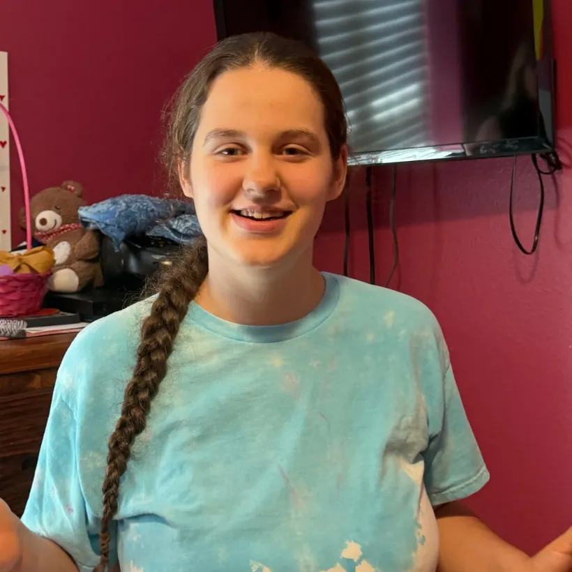 Amy Bateman smiles during a portrait for her Sunshine Communities resident story, celebrating her experiences and connections within the community.