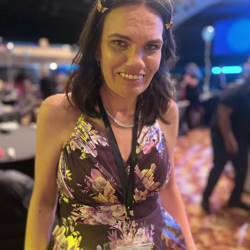 Sunshine Studios artist wearing a floral dress at an iDance event.