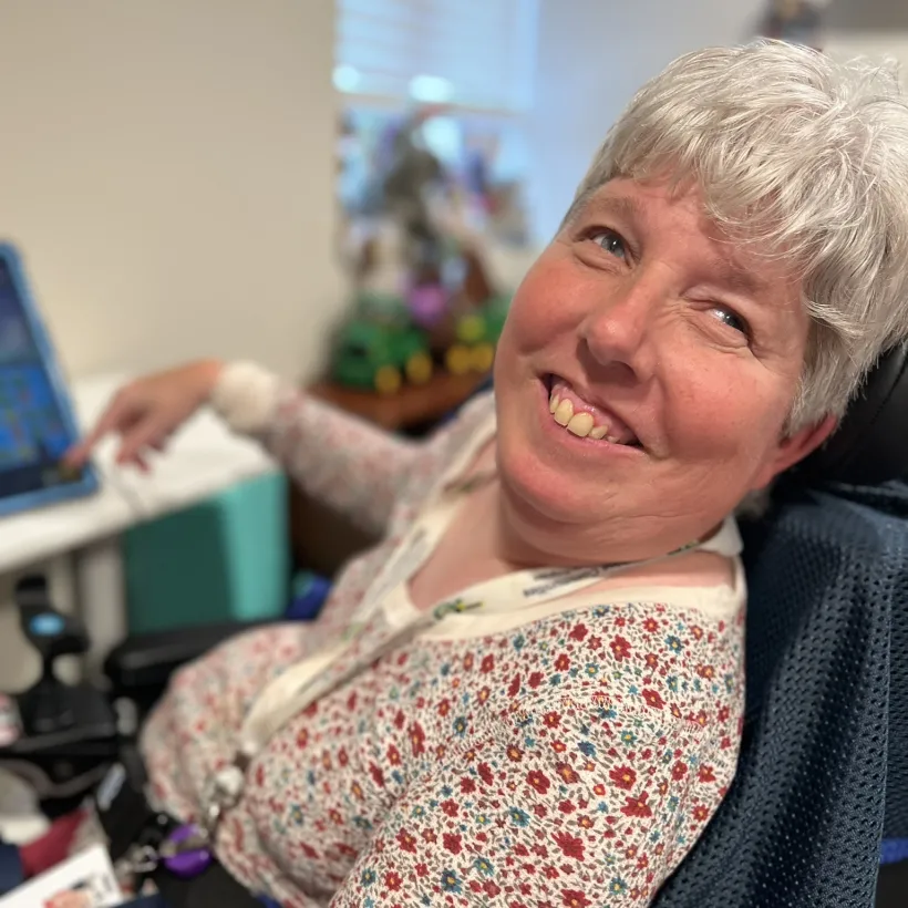 Beth uses a touchscreen tablet with adaptive technology at Sunshine Communities.