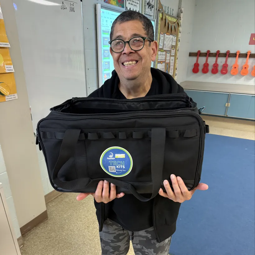 Sunshine Communities participant holds a Tech Kit during an Ohio Tech Day visit to a local school.